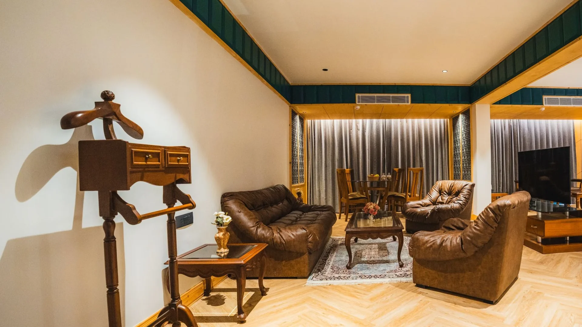 Boutique Suite with leather sofas and a clothes valet