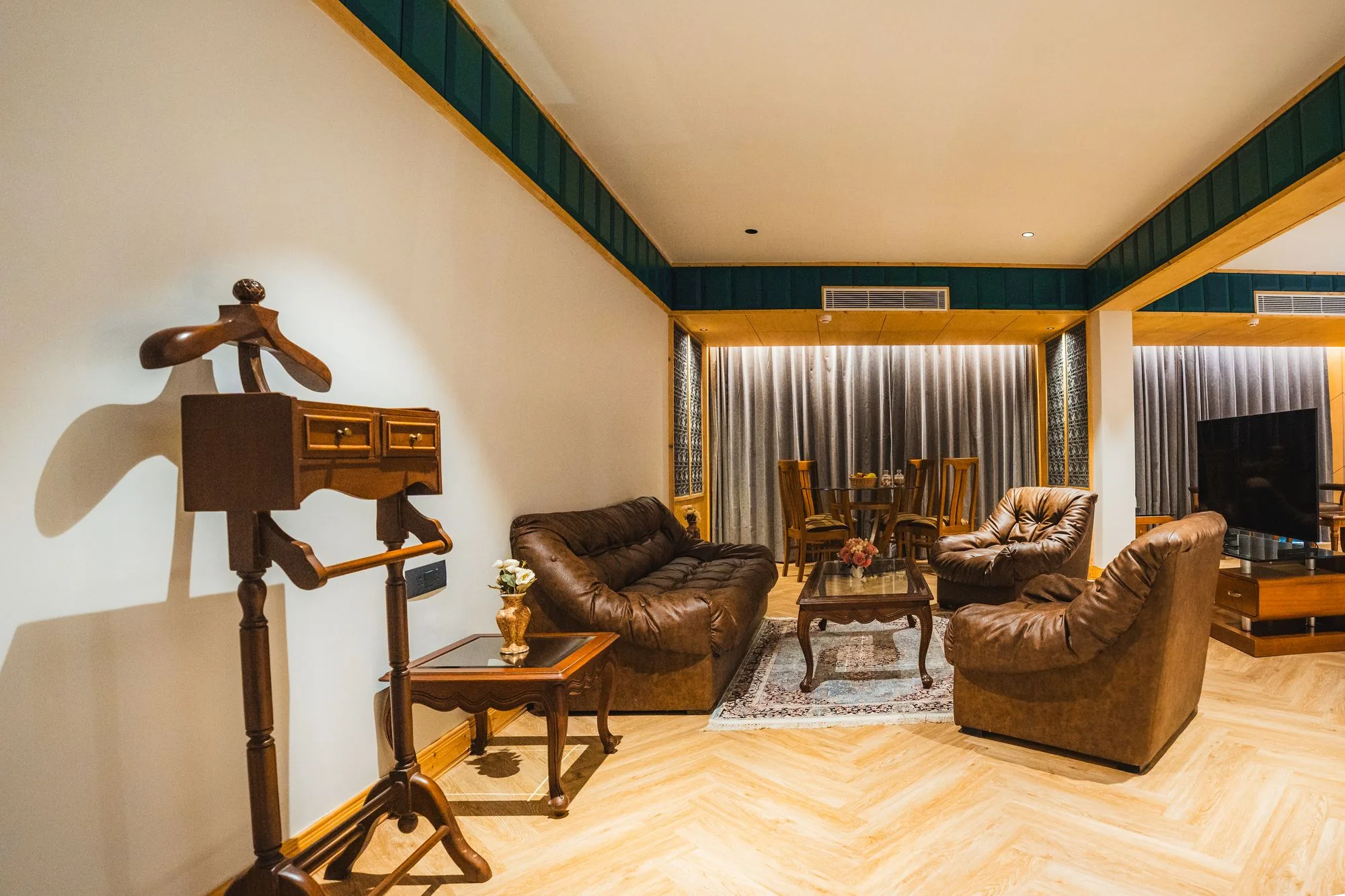 Boutique Suite with leather sofas and a clothes valet