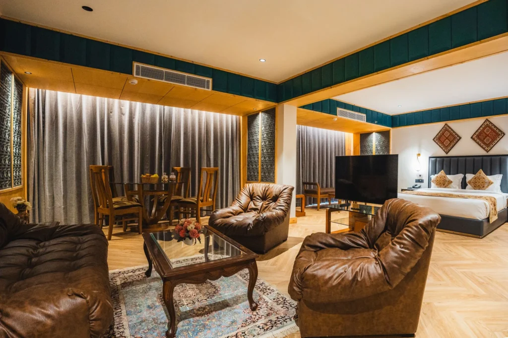 Boutique Suite with king bed, leather sofas and a dining area