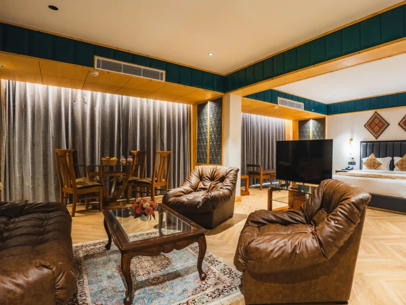 Boutique Suite with king bed, leather sofas and a dining area