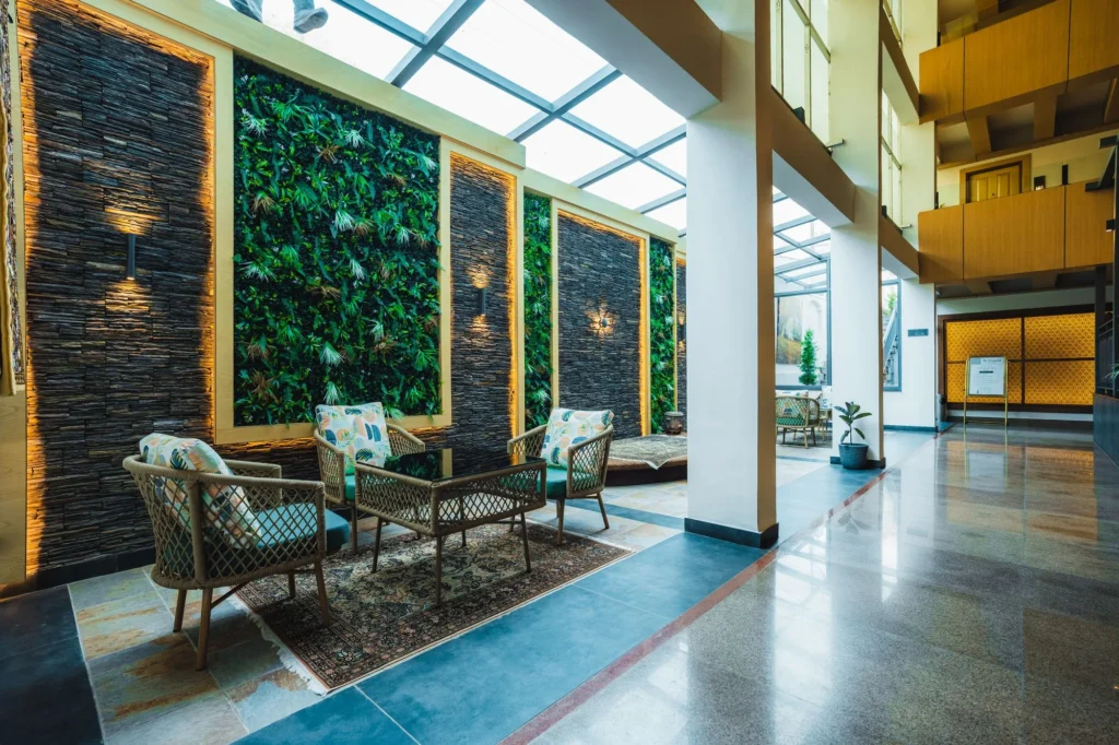 Seating beside a green wall under the glass roof of the atrium