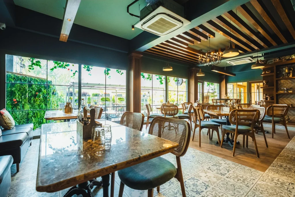 Dining hall at Fatoosh Café with timber ceiling and cane chairs