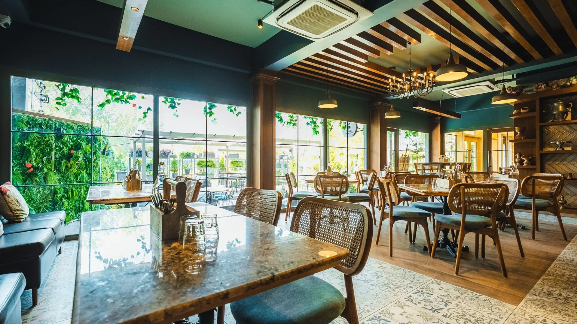 Dining hall at Fatoosh Café with timber ceiling and cane chairs