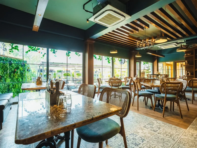 Dining hall at Fatoosh Café with timber ceiling and cane chairs