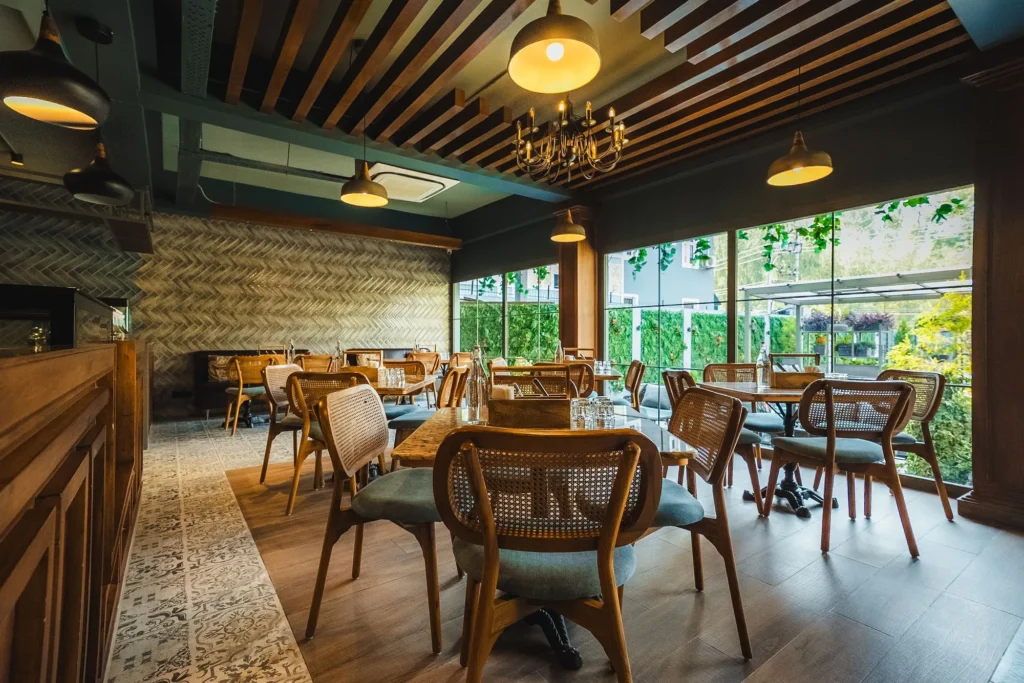 Cane chairs and tables with chandeliers at Fatoosh Café