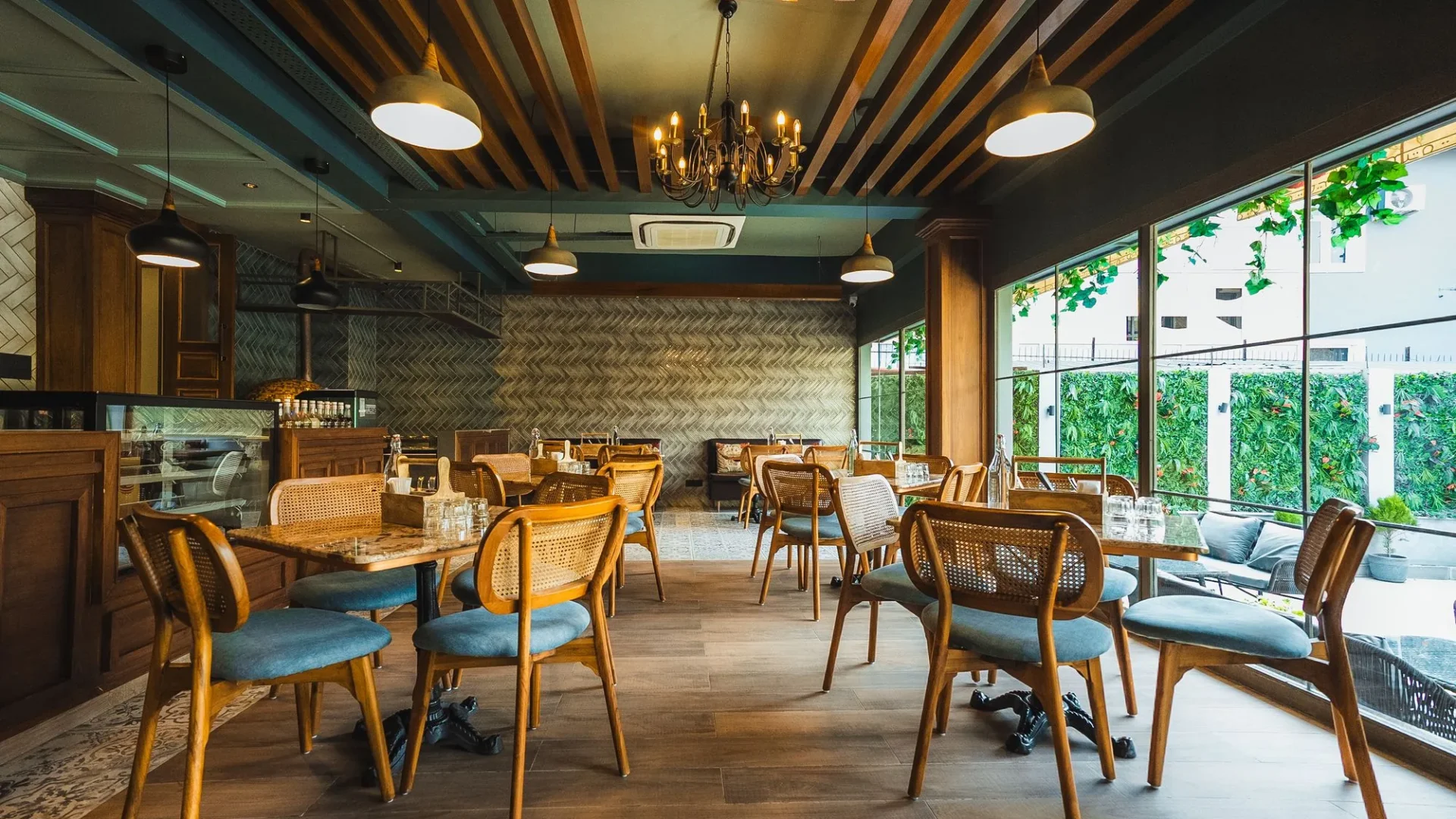 Fatoosh Café dining area with a glass wall to the garden