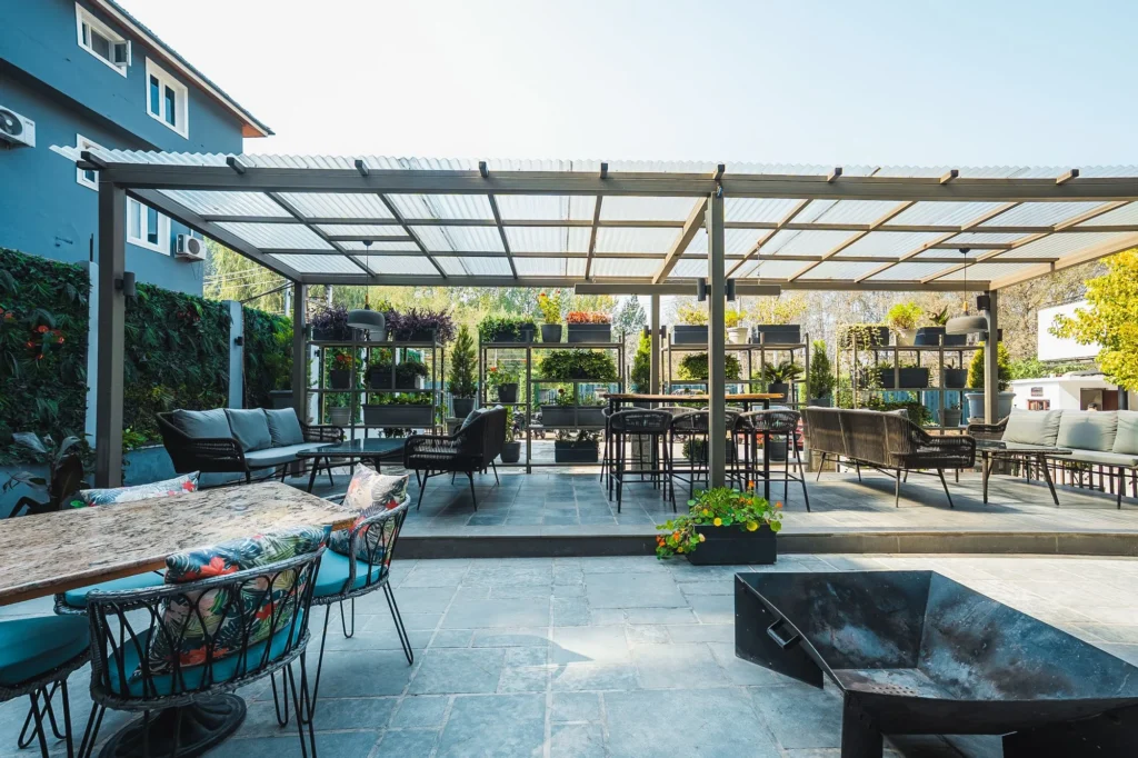 Covered terrace with tables and seating at Fatoosh Café