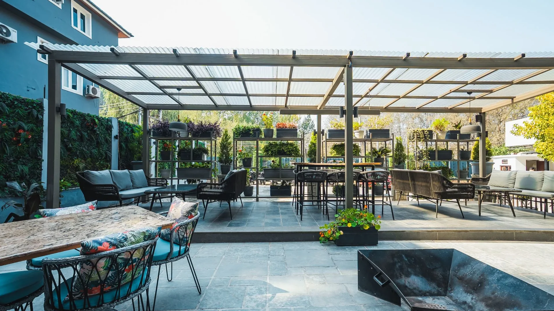 Covered terrace with tables and seating at Fatoosh Café