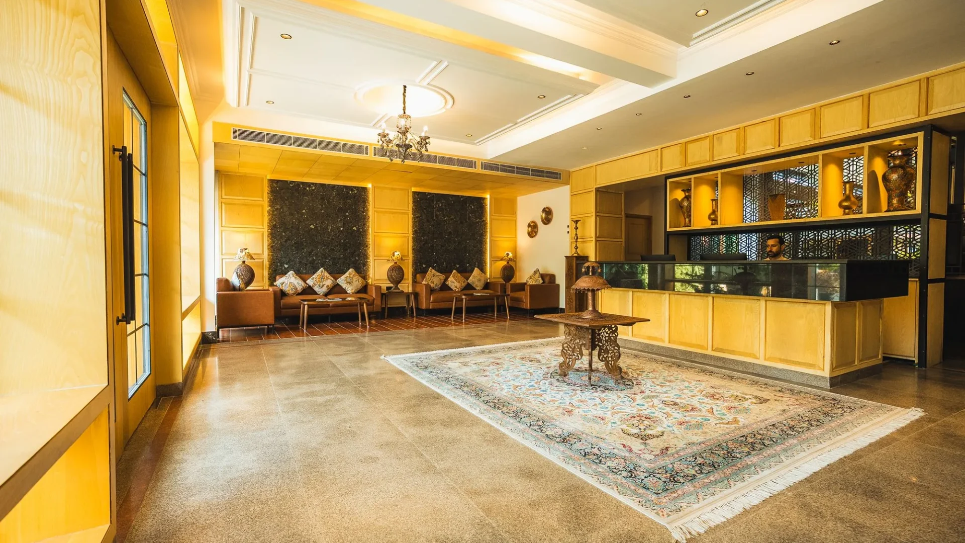Reception lobby with a rug and seating at Wisaal Srinagar