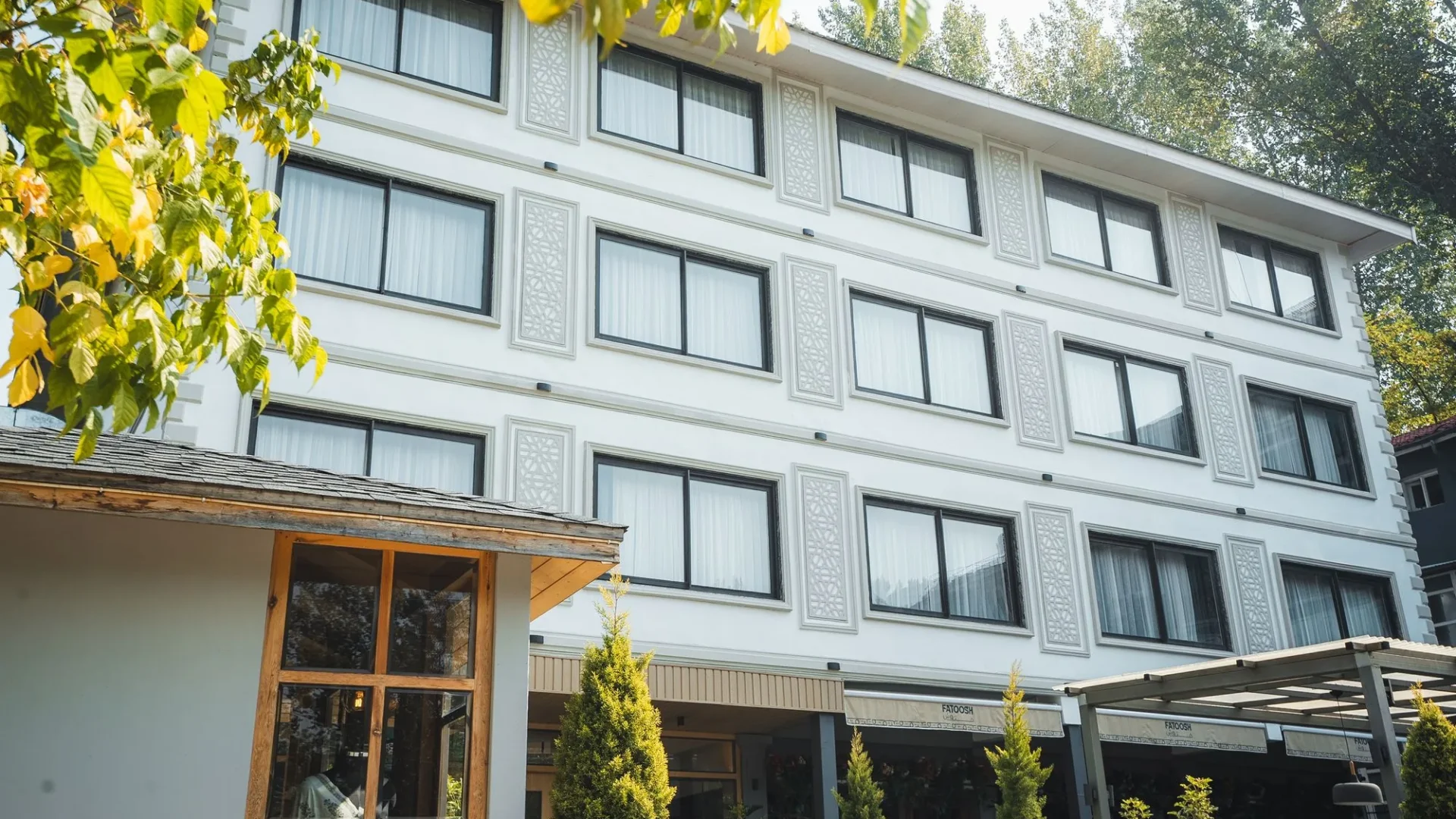 Front of the Wisaal Srinagar building, with windows and a timber entrance