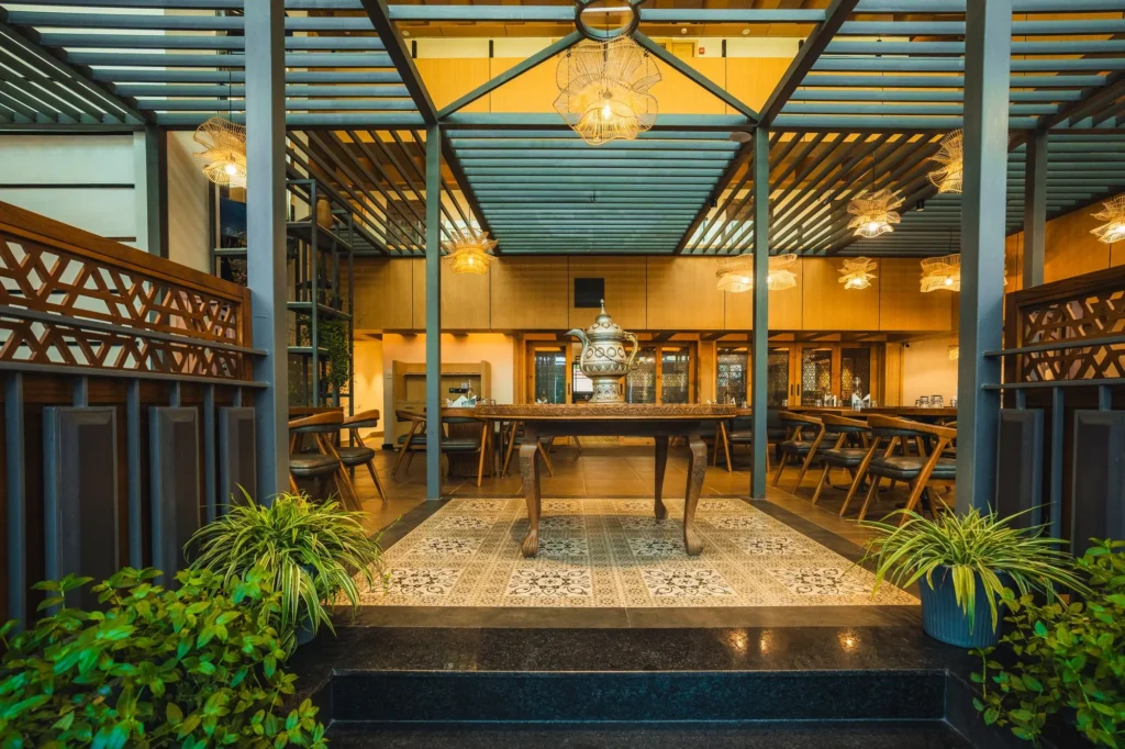 Raised dining area at Nayaab with carved wooden screens