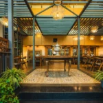 Raised dining area at Nayaab with carved wooden screens