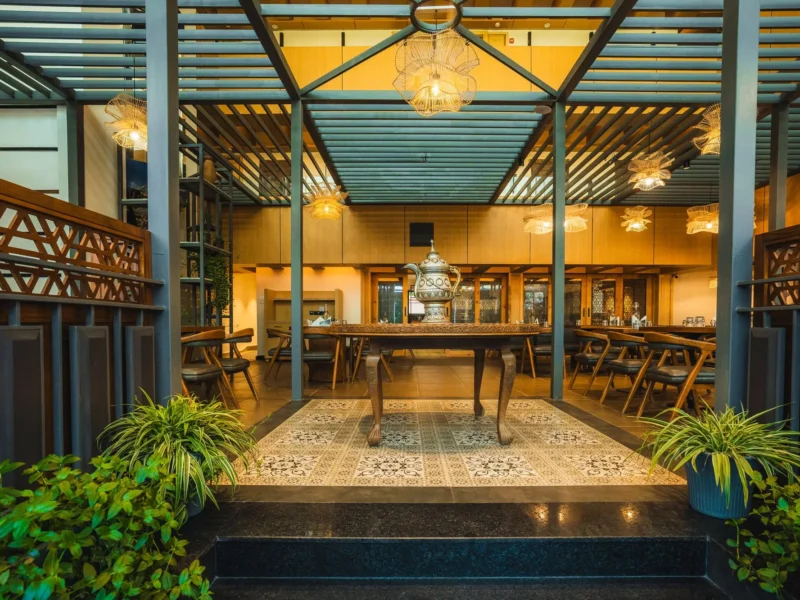 Raised dining area at Nayaab with carved wooden screens