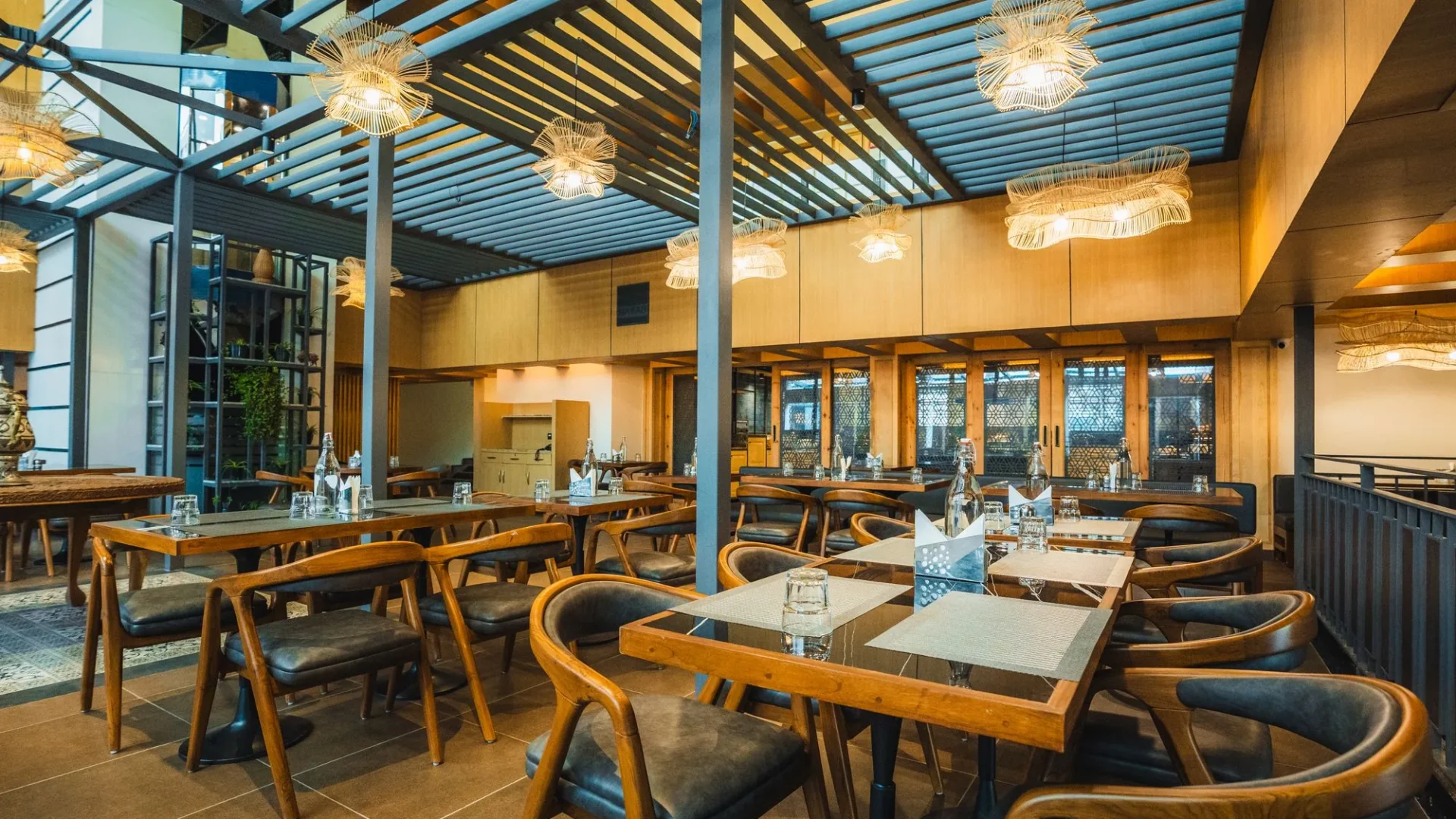 Wooden tables and chairs at Nayaab Restaurant & Lounge