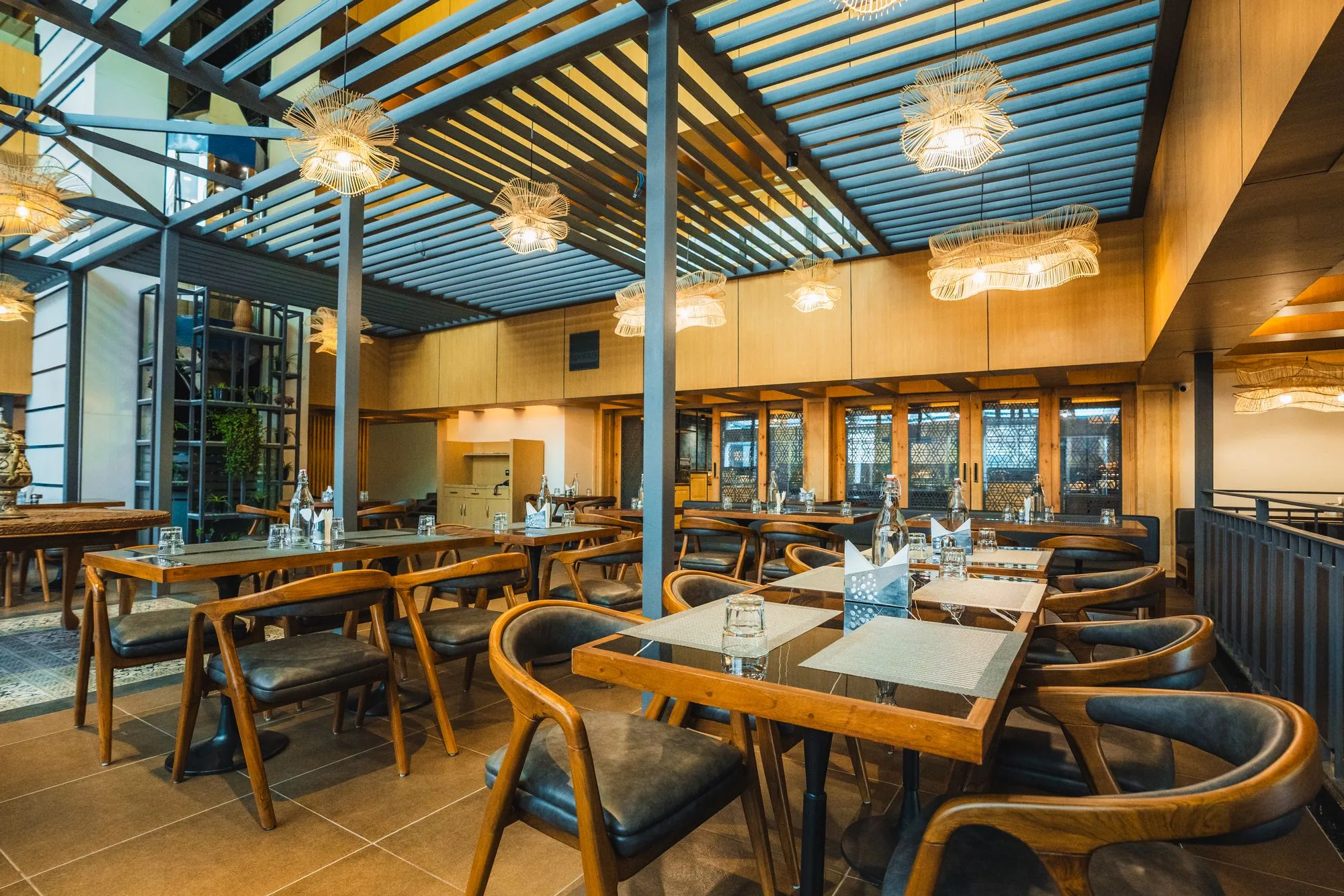 Wooden tables and chairs at Nayaab Restaurant & Lounge