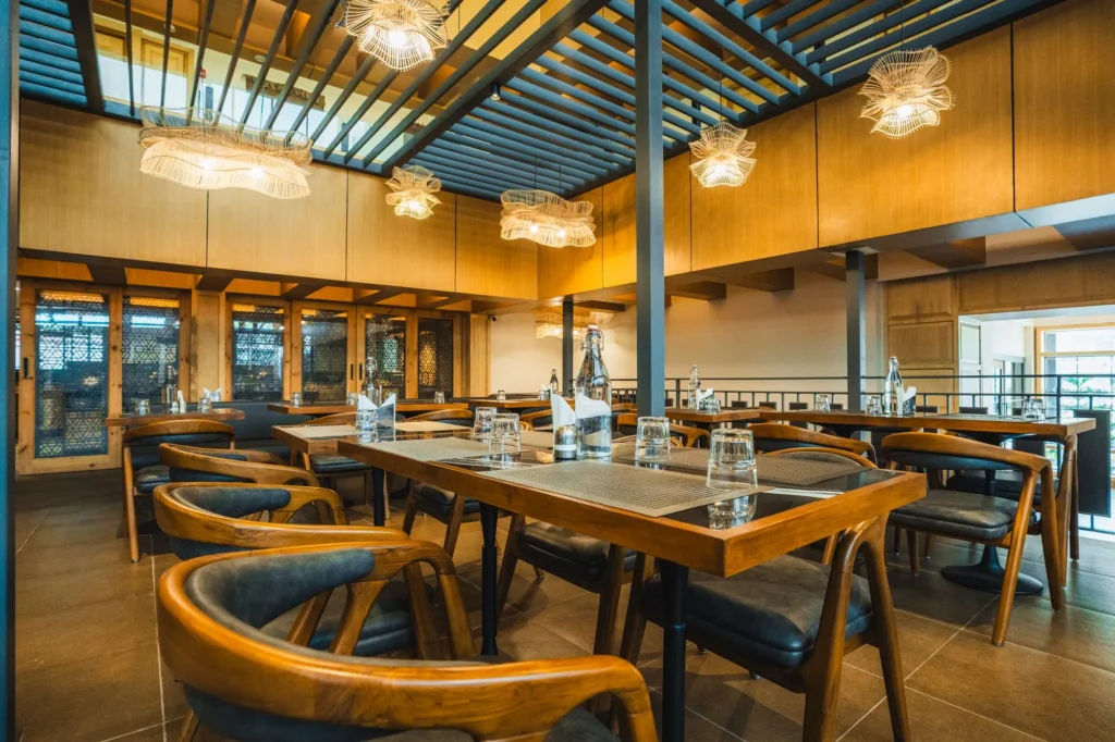Dining hall at Nayaab with a glass roof and pendant lights