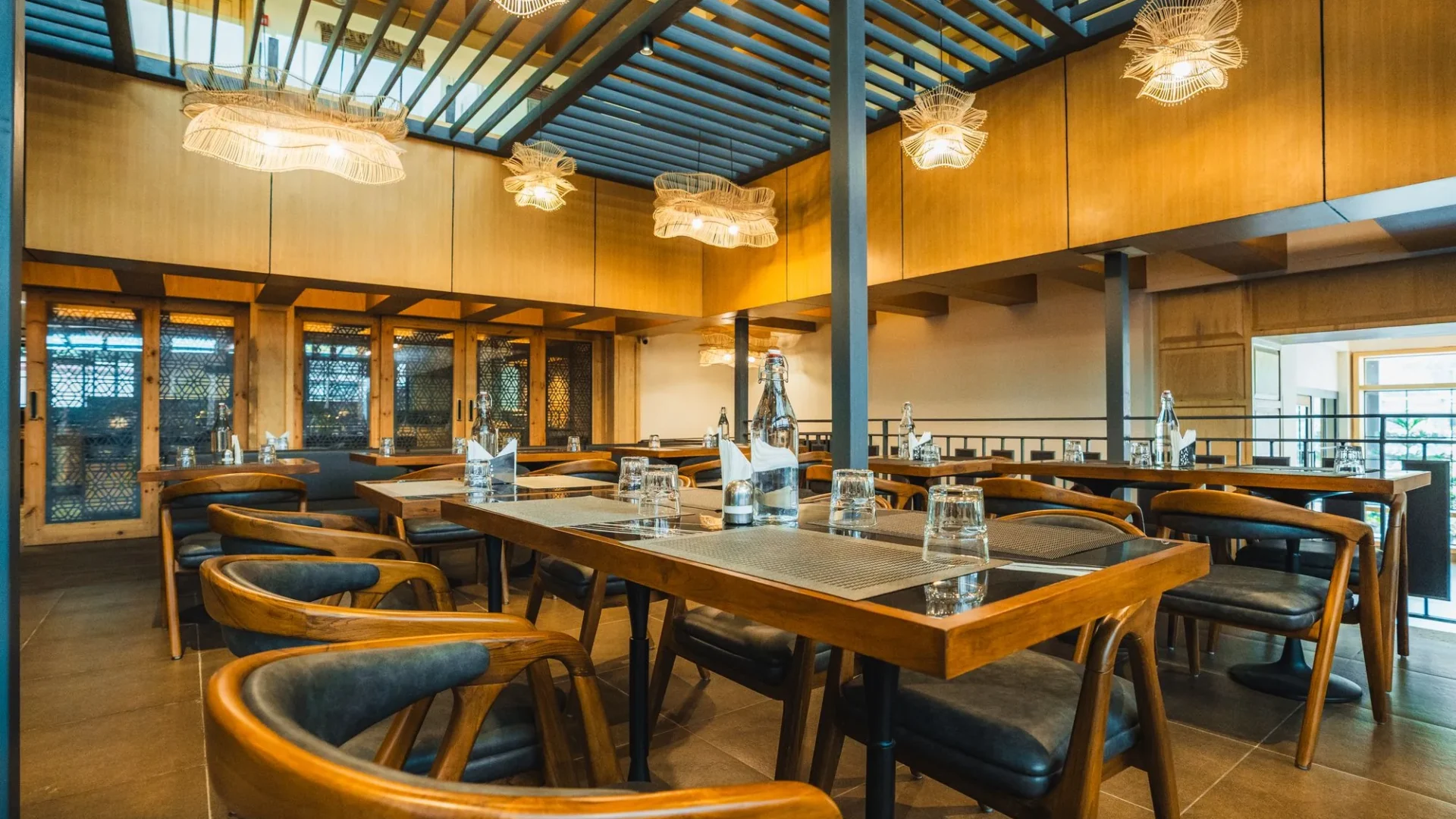 Dining hall at Nayaab with a glass roof and pendant lights