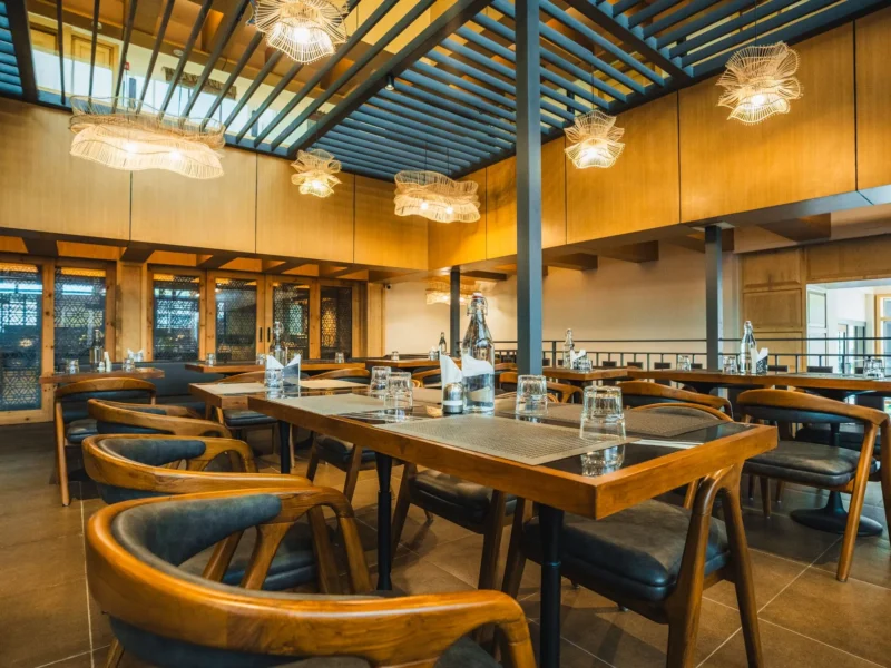 Dining hall at Nayaab with a glass roof and pendant lights