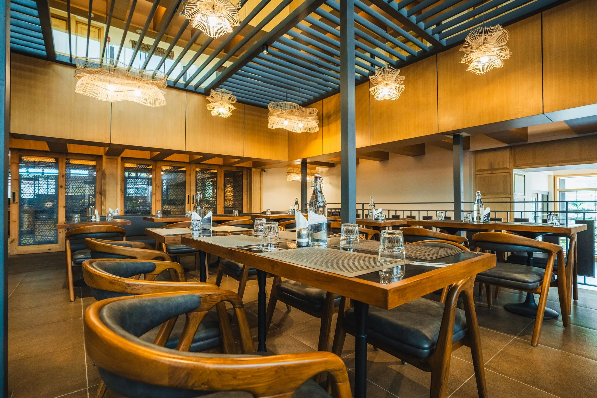 Dining hall at Nayaab with a glass roof and pendant lights