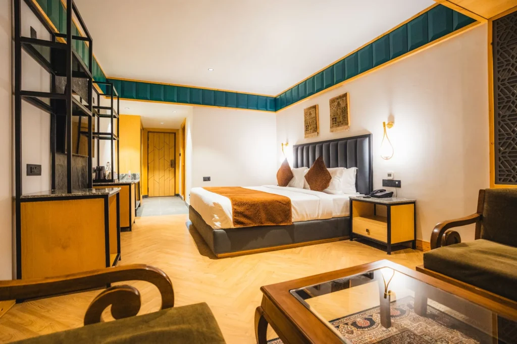 Premium Room with bed, armchair and coffee table