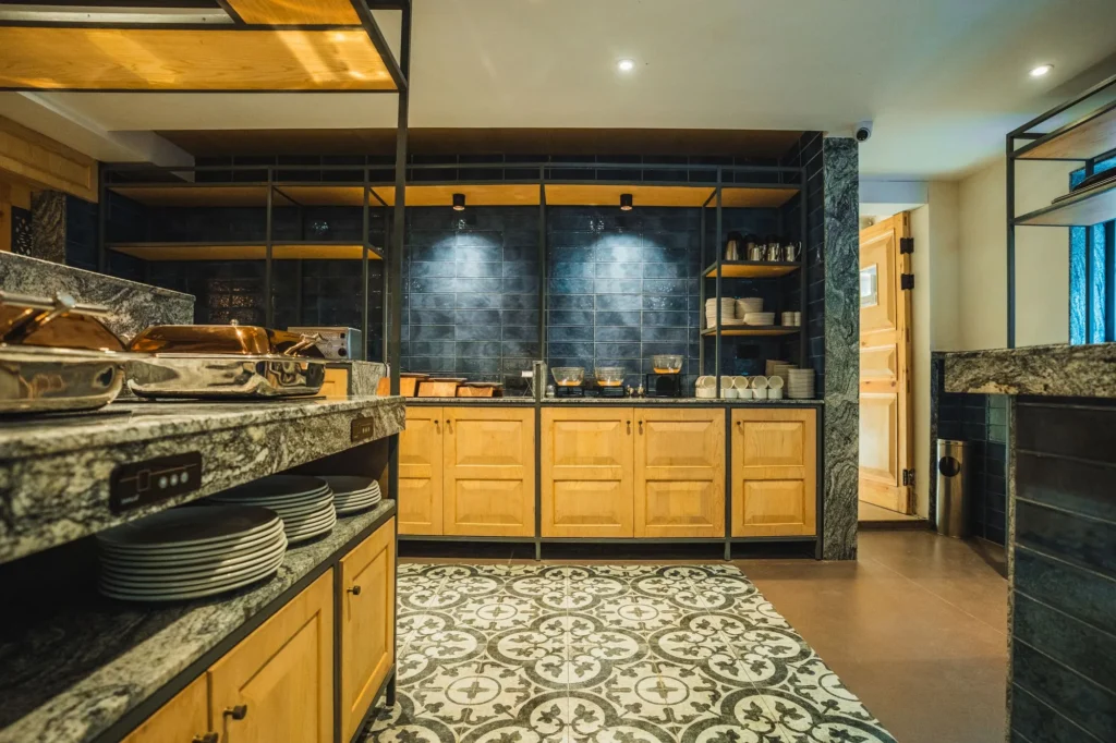 Buffet counter at the restaurant with plates and wooden cabinets