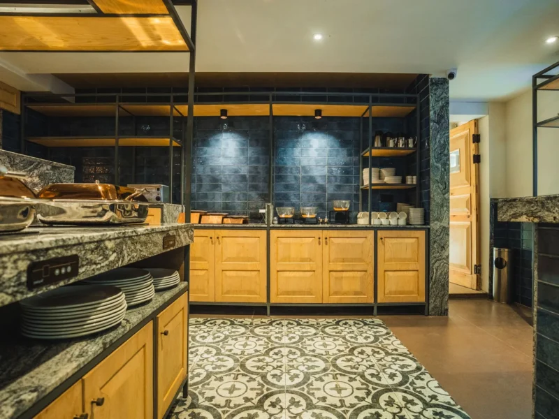 Buffet counter at the restaurant with plates and wooden cabinets