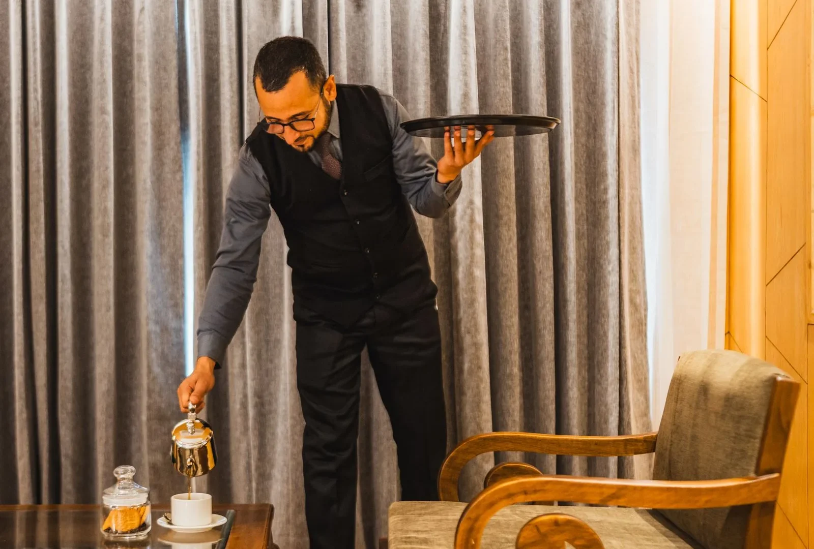 Waiter bringing a tray to a guest room