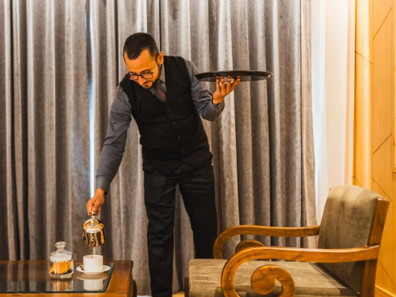 Waiter bringing a tray to a guest room