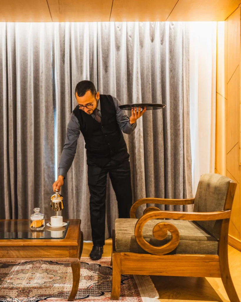 Waiter bringing a tray to a guest room