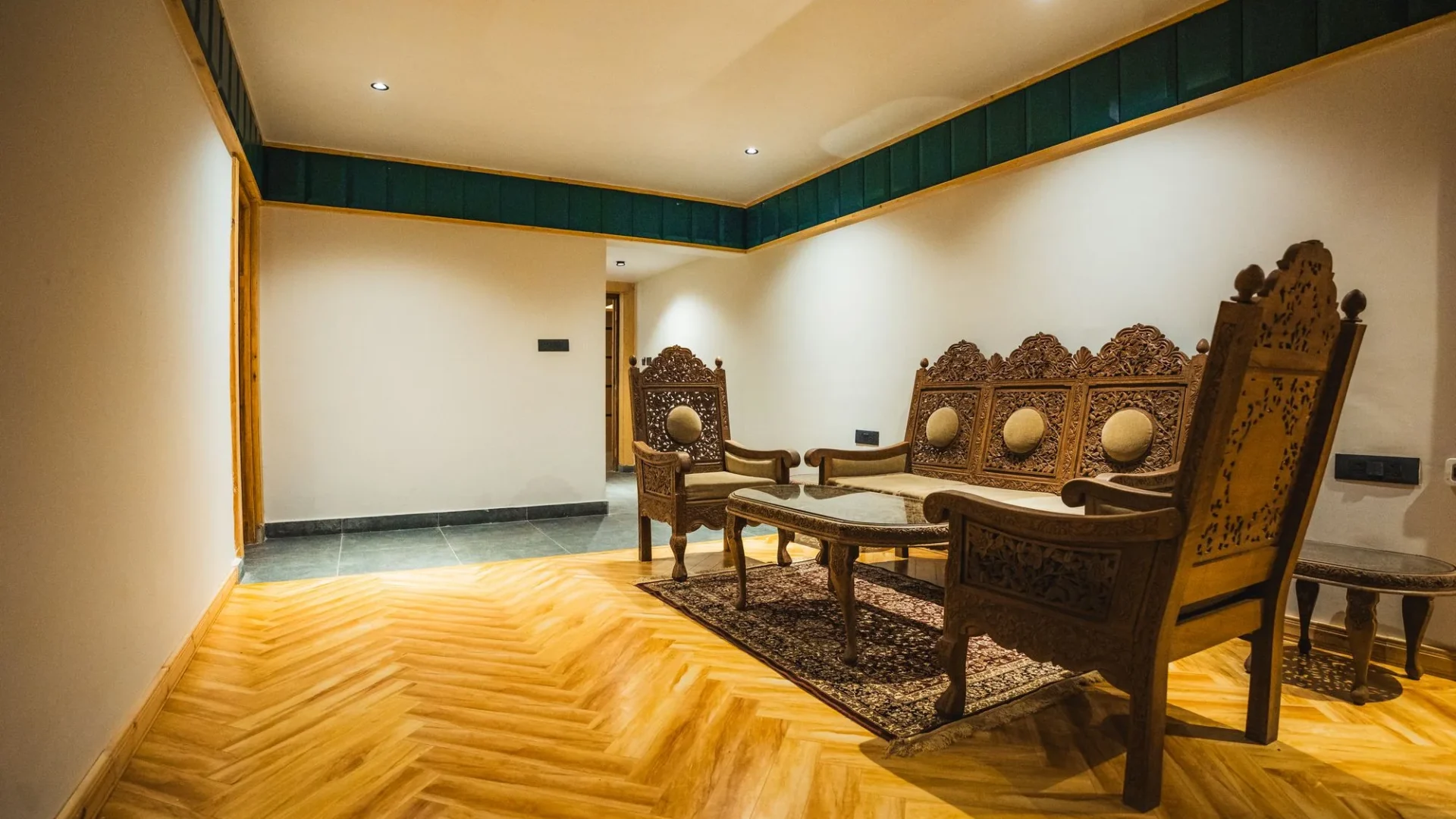 Suite sitting area with carved wooden furniture