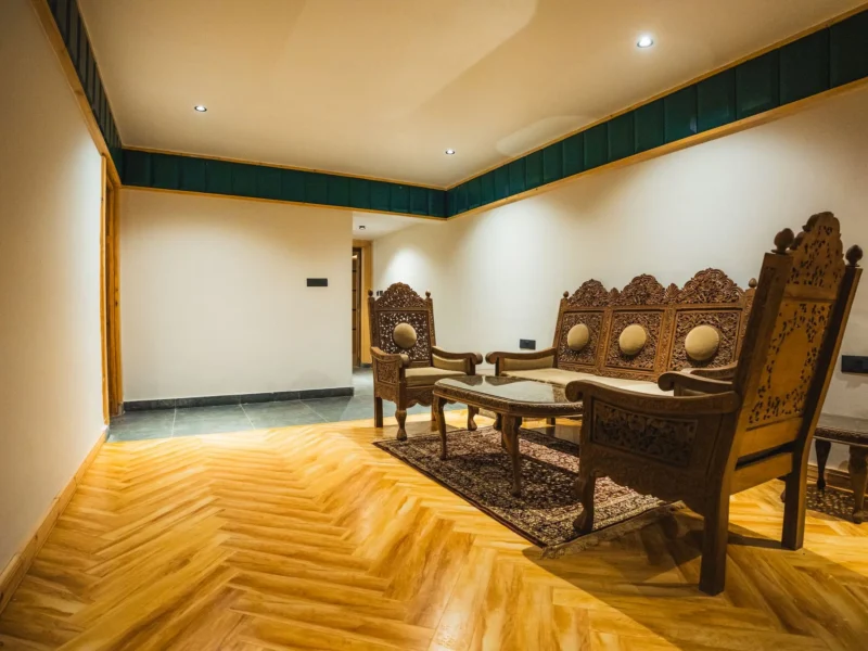 Suite sitting area with carved wooden furniture