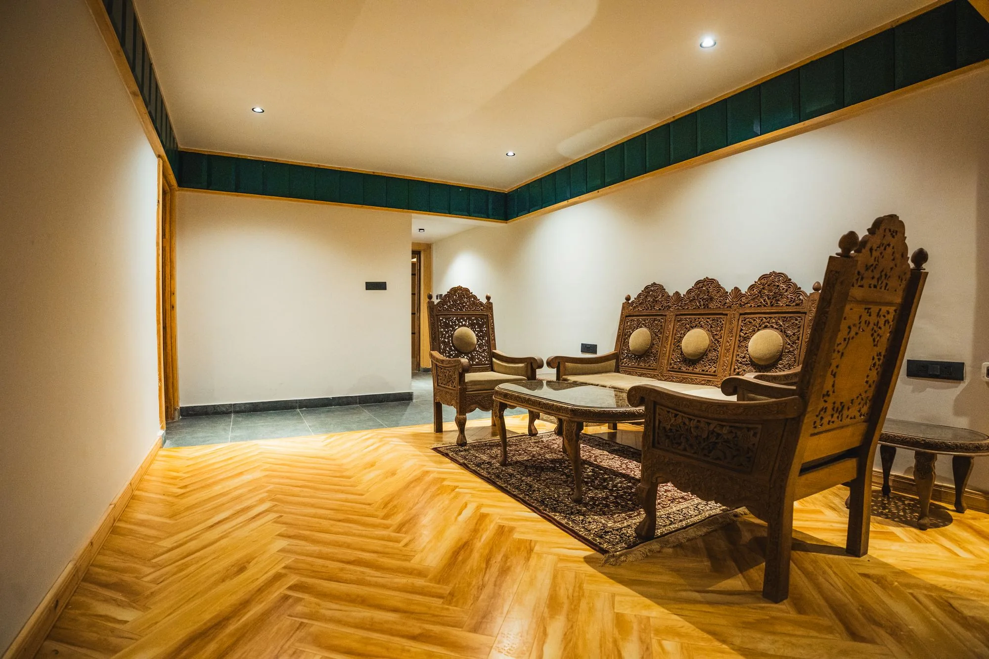Suite sitting area with carved wooden furniture
