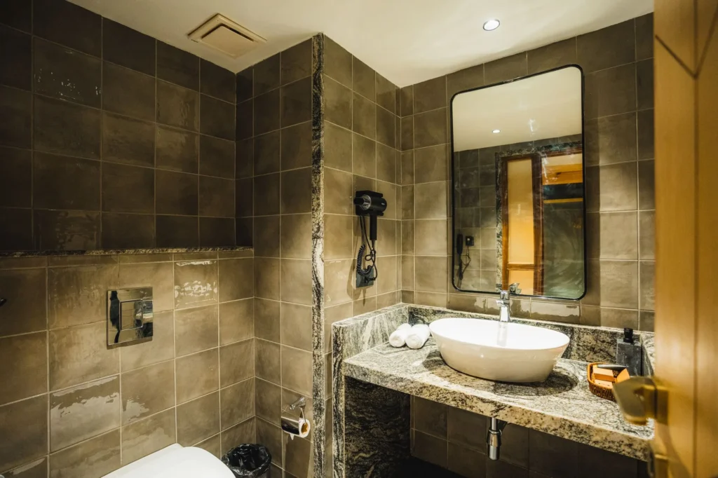 Stone-walled bathroom with a vanity and mirror