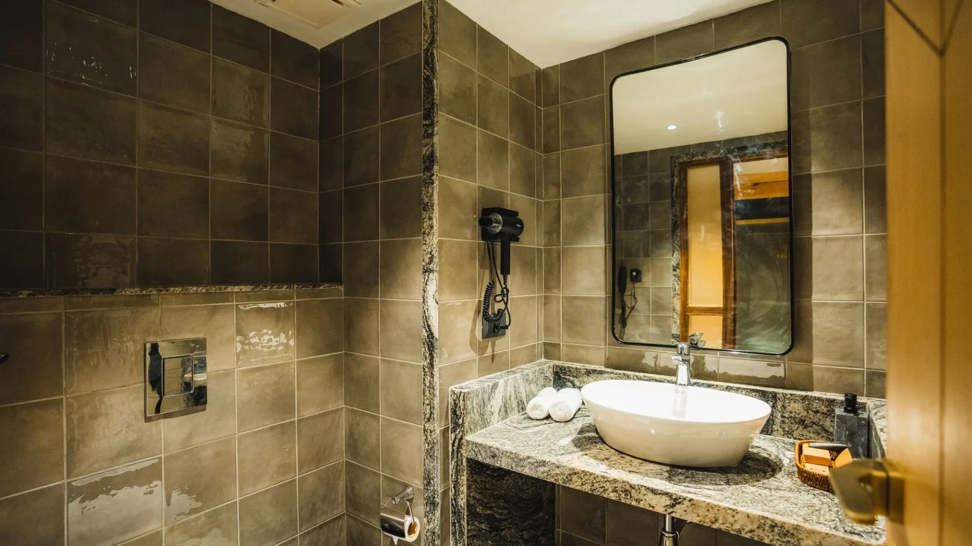 Stone-walled bathroom with a vanity and mirror