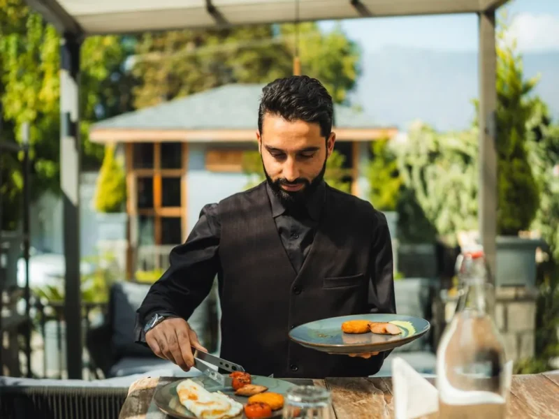 Waiter serving breakfast on the terrace