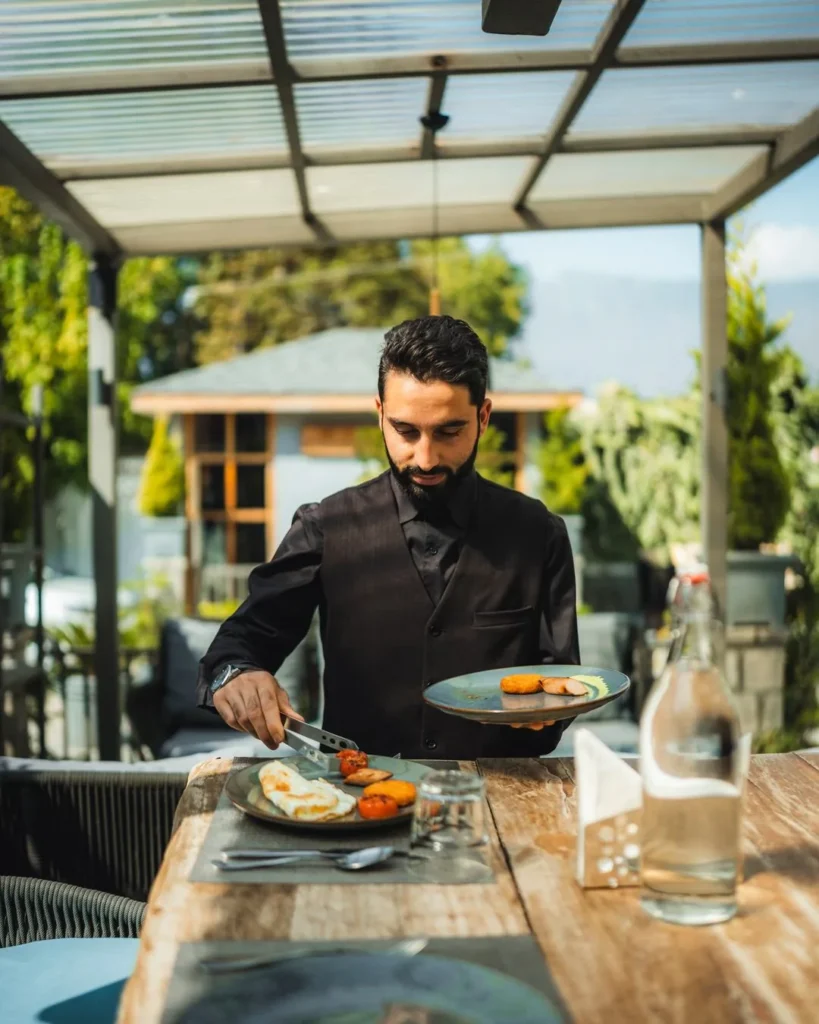 Waiter serving breakfast on the terrace