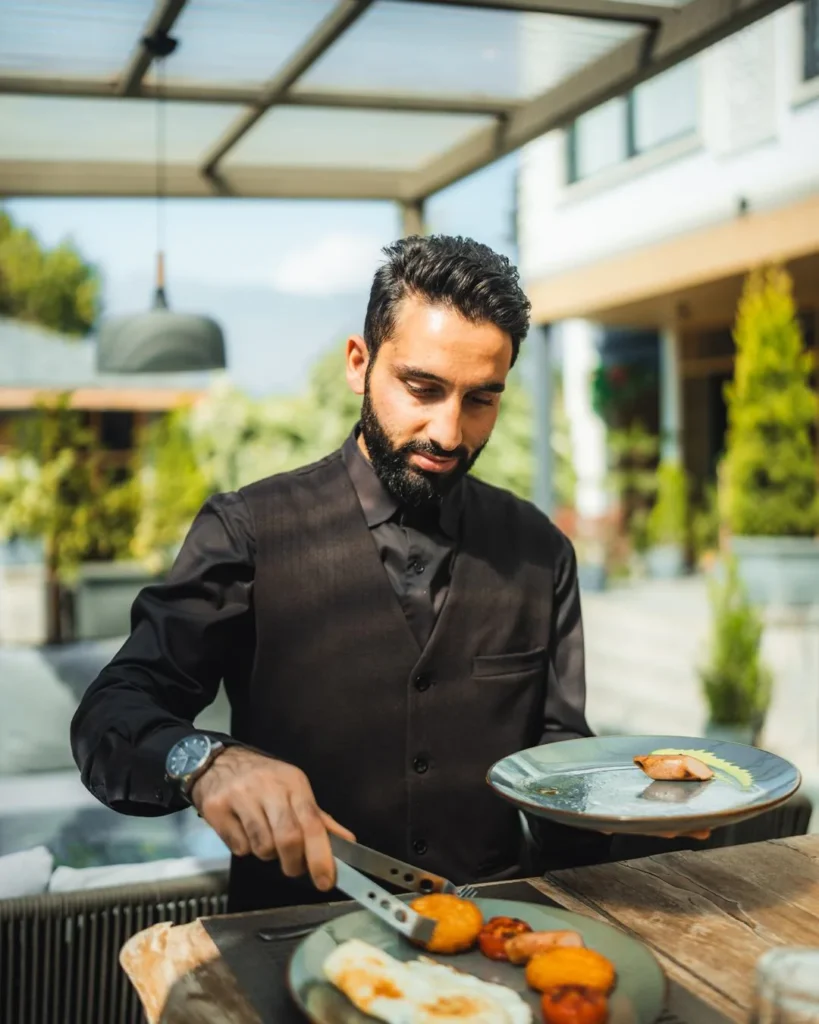Waiter serving a plate at the terrace table